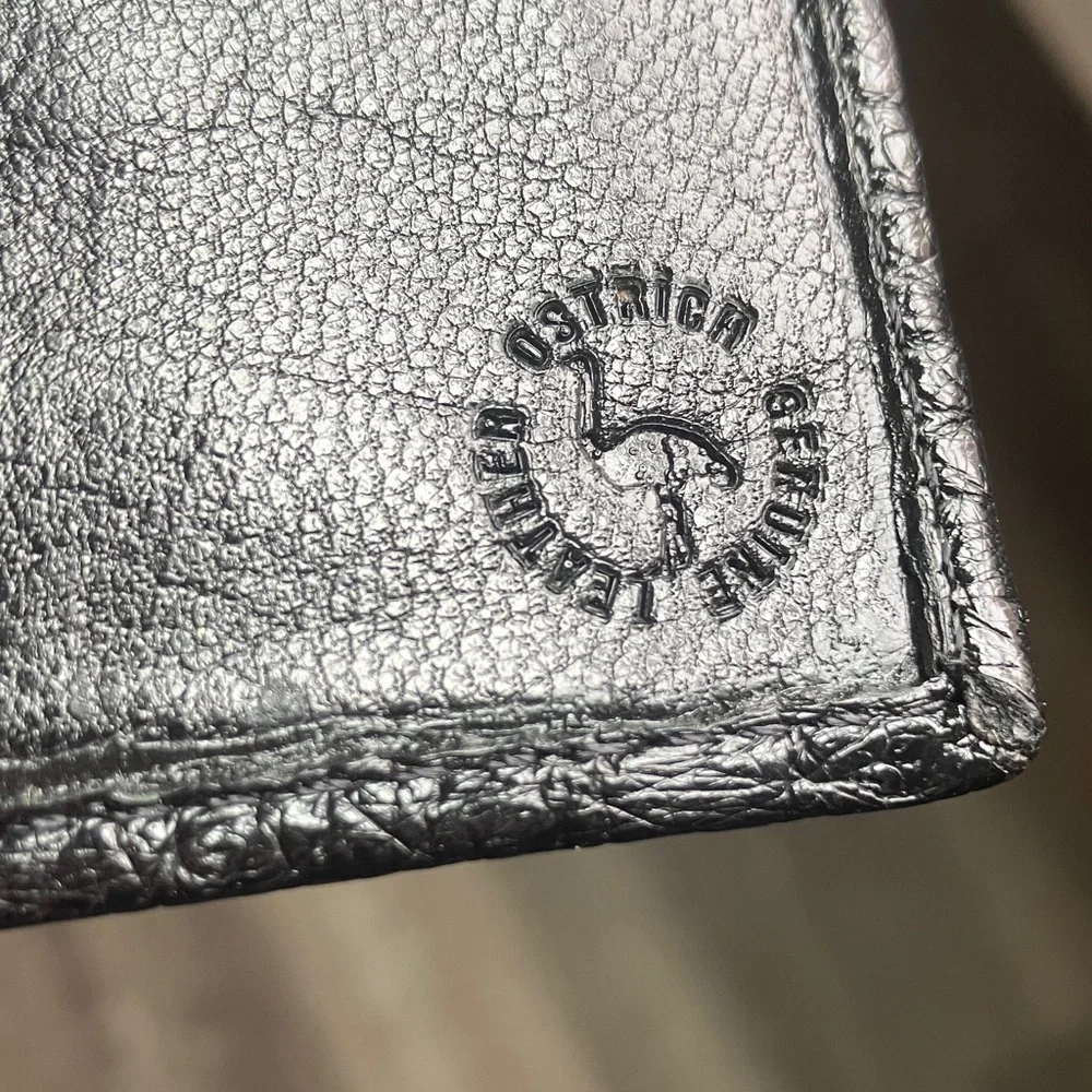 black bifold wallet made from genuine ostrich leather.